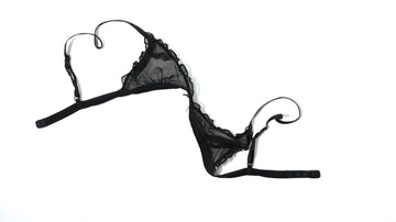 Black sheer mesh bralette laid flat on a white background, for a guide to comfortable bra alternatives for women, from nipple covers to boob tape and sticky bras