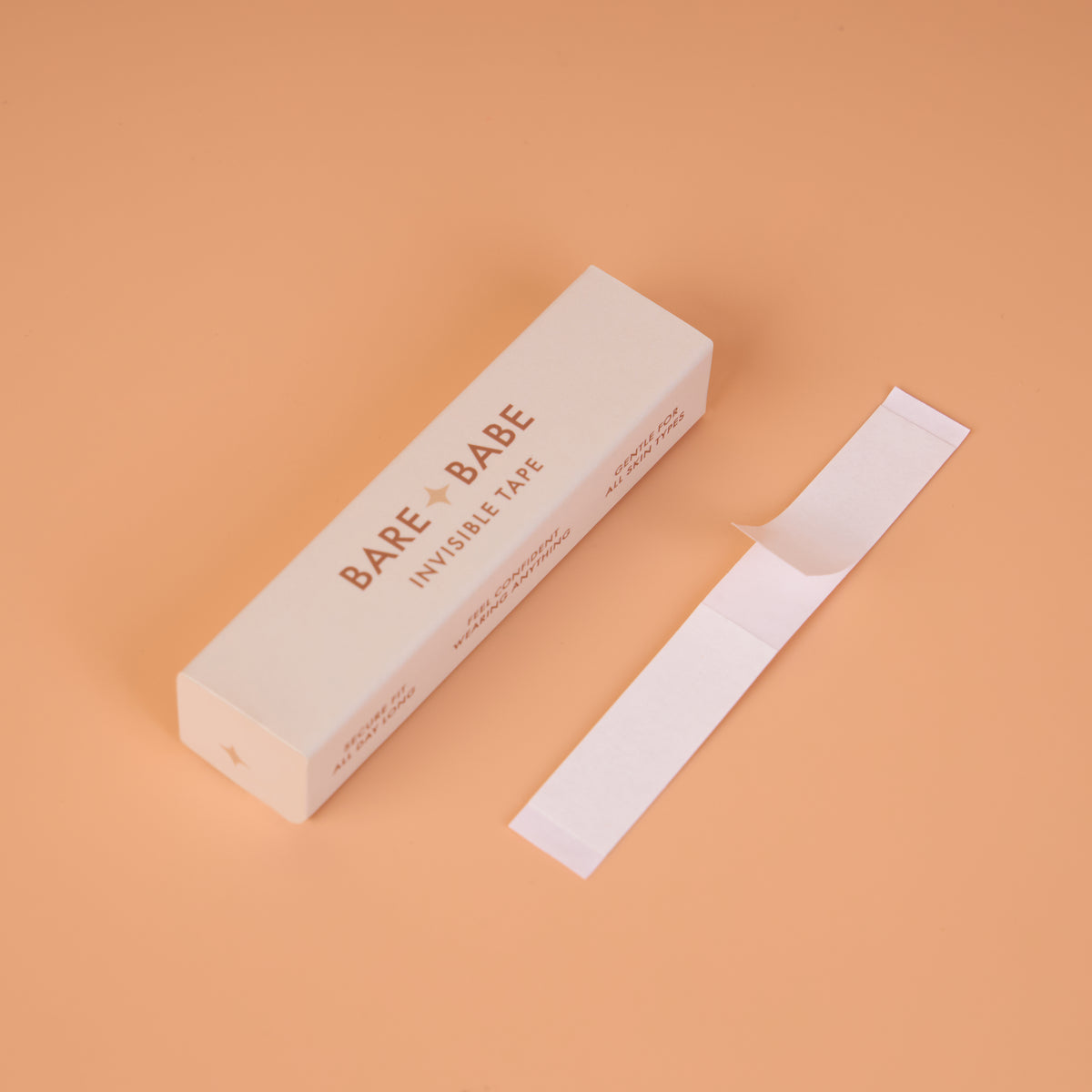 Invisible Lingerie Tape box beside a single strip with its backing partly peeled back, showing the pre-cut double-sided tape for clothes and body.