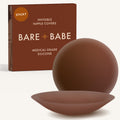 Adhesive Nipple Covers in Mocha: a pair of round, matte, reusable silicone nipple covers, one tilted to show the sticky side, in front of the Mocha box marked Sticky and medical-grade silicone.