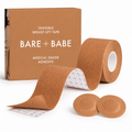Boob Tape Kit in Caramel: a roll of breast lift tape with grid backing for cutting strips, two matching round satin pasties to cover the nipple first, and the Caramel box marked medical-grade adhesive.