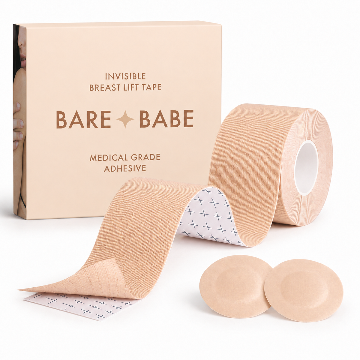 Boob Tape Kit in Creme: a roll of breast lift tape with grid backing for cutting strips, two round satin pasties to cover the nipple first, and the Creme box marked medical-grade adhesive.