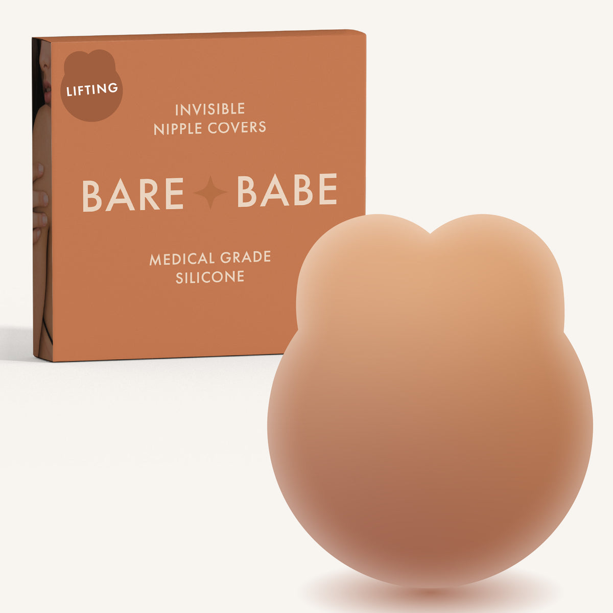 Lifting Nipple Covers (Two-Tabs) in Caramel: two-tab reusable silicone lift nipple cover in front of its Caramel Bare Babe box, labelled Lifting, invisible nipple covers, medical grade silicone