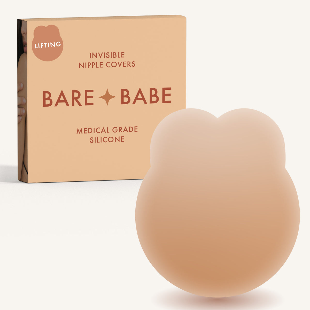 Lifting Nipple Covers (Two-Tabs) in Honey: two-tab reusable silicone lift nipple cover in front of its Honey Bare Babe box, labelled Lifting, invisible nipple covers, medical grade silicone
