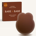 Lifting Nipple Covers (Two-Tabs) in Mocha: two-tab reusable silicone lift nipple cover in front of its Mocha Bare Babe box, labelled Lifting, invisible nipple covers, medical grade silicone