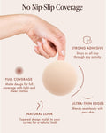Adhesive Nipple Covers infographic, No Nip-Slip Coverage: a hand holds a round Creme silicone cover. Features: strong adhesive that stays put, matte full coverage under tight and sheer clothes, ultra-thin edges that blend with your skin, and a tapered design that molds to your curves.