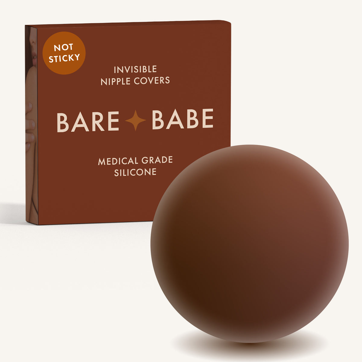 Non-Adhesive Nipple Covers in Mocha: a round, matte, grippy silicone nipple cover in front of the Mocha Bare Babe box marked Not Sticky and medical-grade silicone, reusable with no adhesive.
