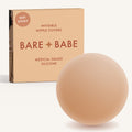 Non-Adhesive Nipple Covers in Honey: a round, matte, grippy silicone nipple cover in front of the Honey Bare Babe box marked Not Sticky and medical-grade silicone, reusable with no adhesive.