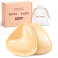 Extra-Boost Sticky Push Up Inserts in Honey, a pair of double-sided sticky push-up bra inserts in front of the Bare Babe Push Up box and white drawstring travel bag