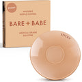 Sensitive Adhesive Nipple Covers in Honey: a round sticky silicone cover marked Sticky, with its adhesive-free center ring visible, in front of the Honey Bare Babe box in medical-grade silicone.