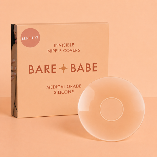 Sensitive Adhesive Nipple Covers: a round sticky silicone nipple cover turned to show its adhesive-free center ring, standing beside the Bare Babe Sensitive invisible nipple covers box in medical-grade silicone.