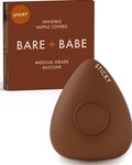 Sensitive Triangle Nipple Covers in Mocha: a rounded-triangle sticky silicone nipple cover marked Sticky, with its adhesive-free center ring, in front of the Mocha Bare Babe box in medical-grade silicone.