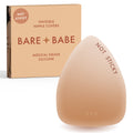 Triangle Non-Adhesive Nipple Covers in Honey: grippy, not sticky triangle silicone nipple cover marked Not Sticky, in front of its Honey Bare Babe box, invisible nipple covers in medical grade silicone
